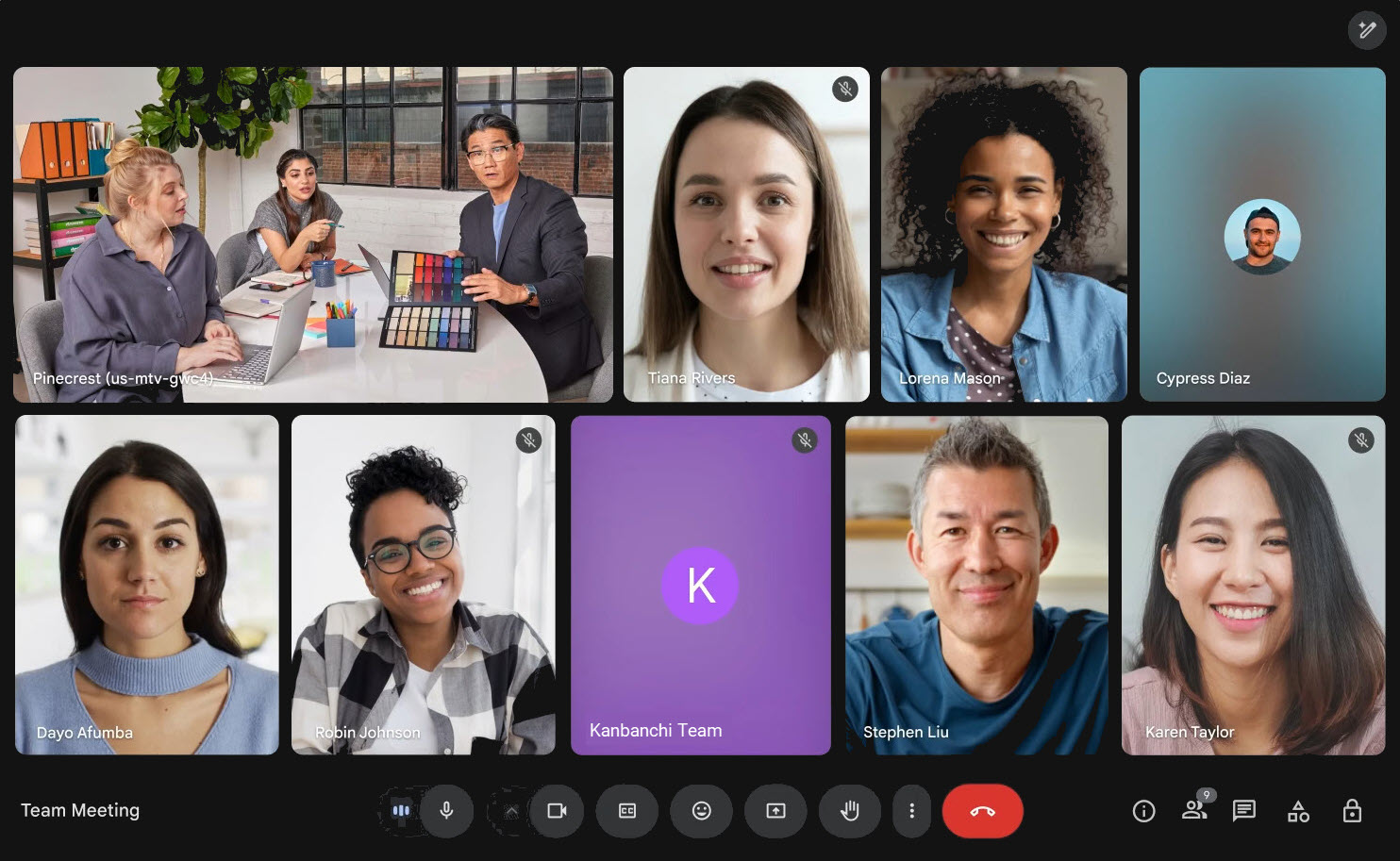 A screenshot of a Google Meet video conference call featuring a diverse team of remote workers and a group in a conference room, illustrating virtual team collaboration.