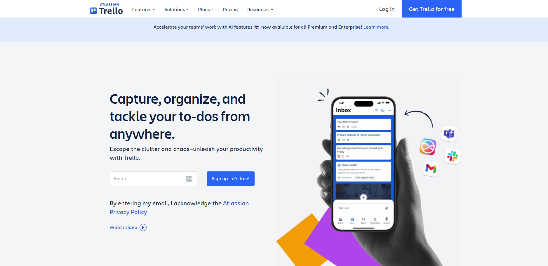 A screenshot of the Trello website homepage displaying the headline "Capture, organize, and tackle your to-dos from anywhere" beside a hand holding a smartphone showing a mobile task list